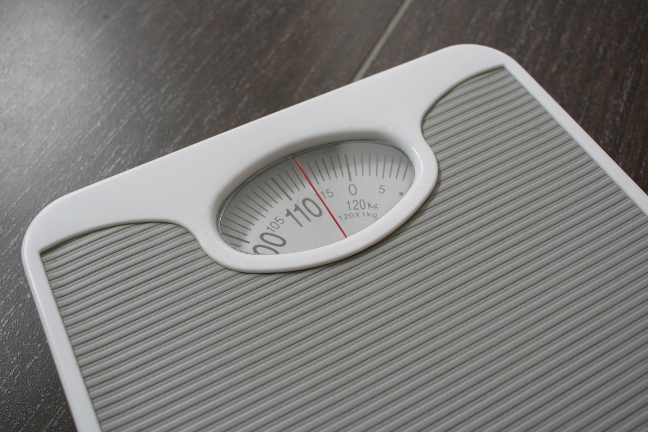 person weighing on scale person weighing on scale