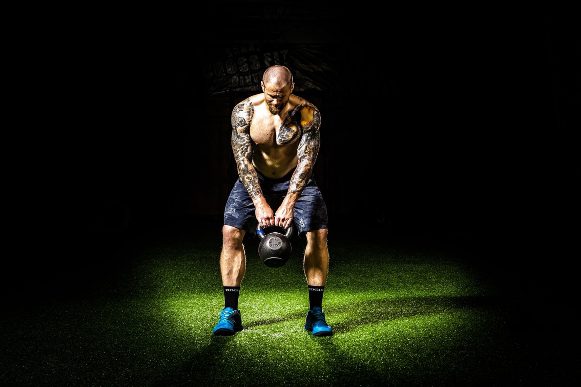 person doing kettlebell swings person doing kettlebell swings