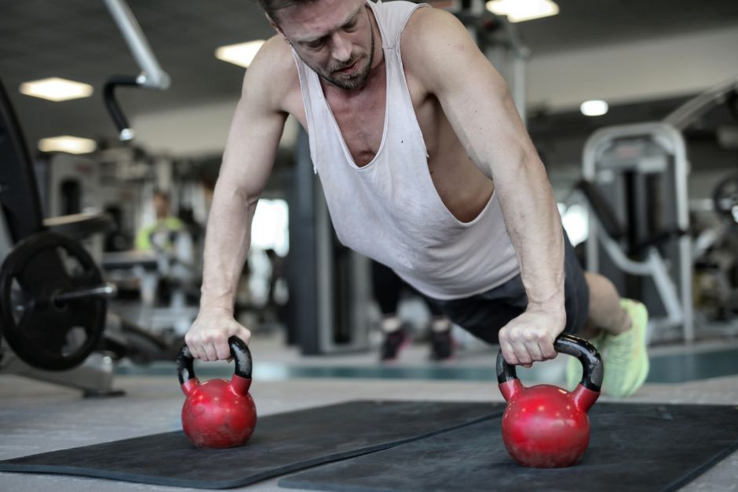 person doing pushups on kettlebells person doing pushups on kettlebells