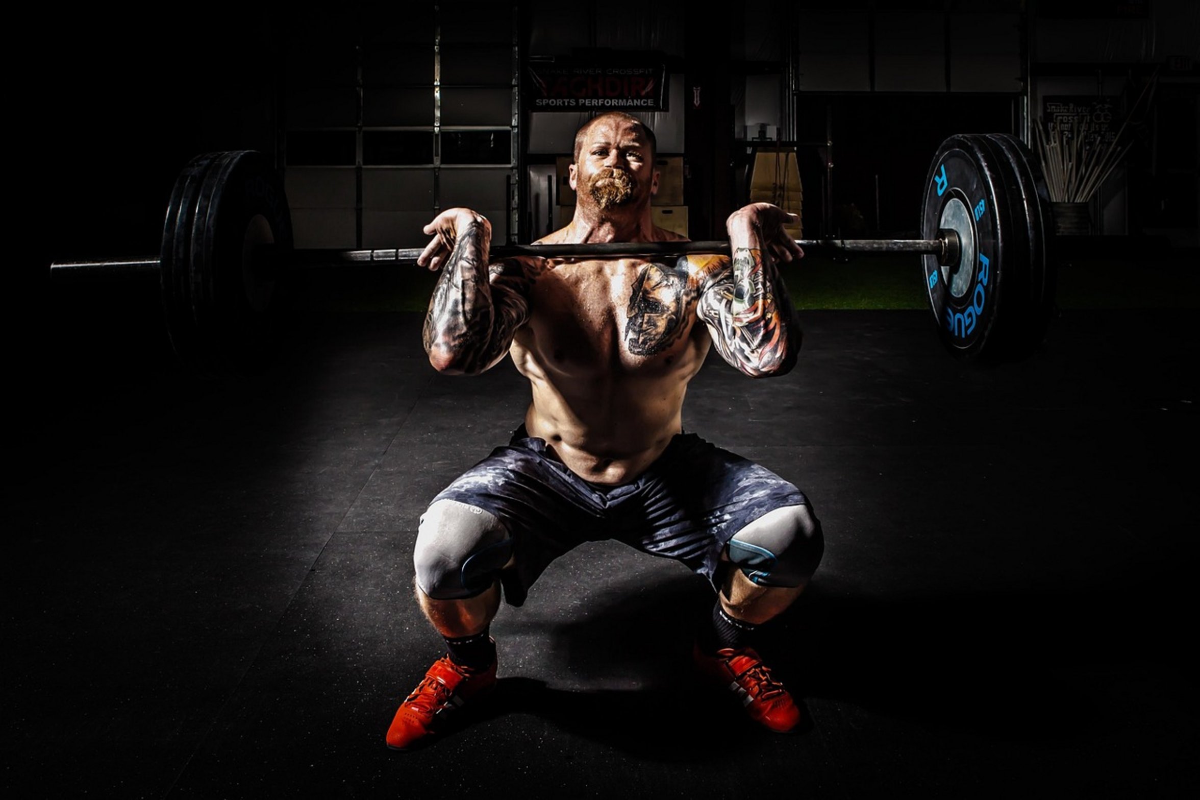 person holding barbell person holding barbell