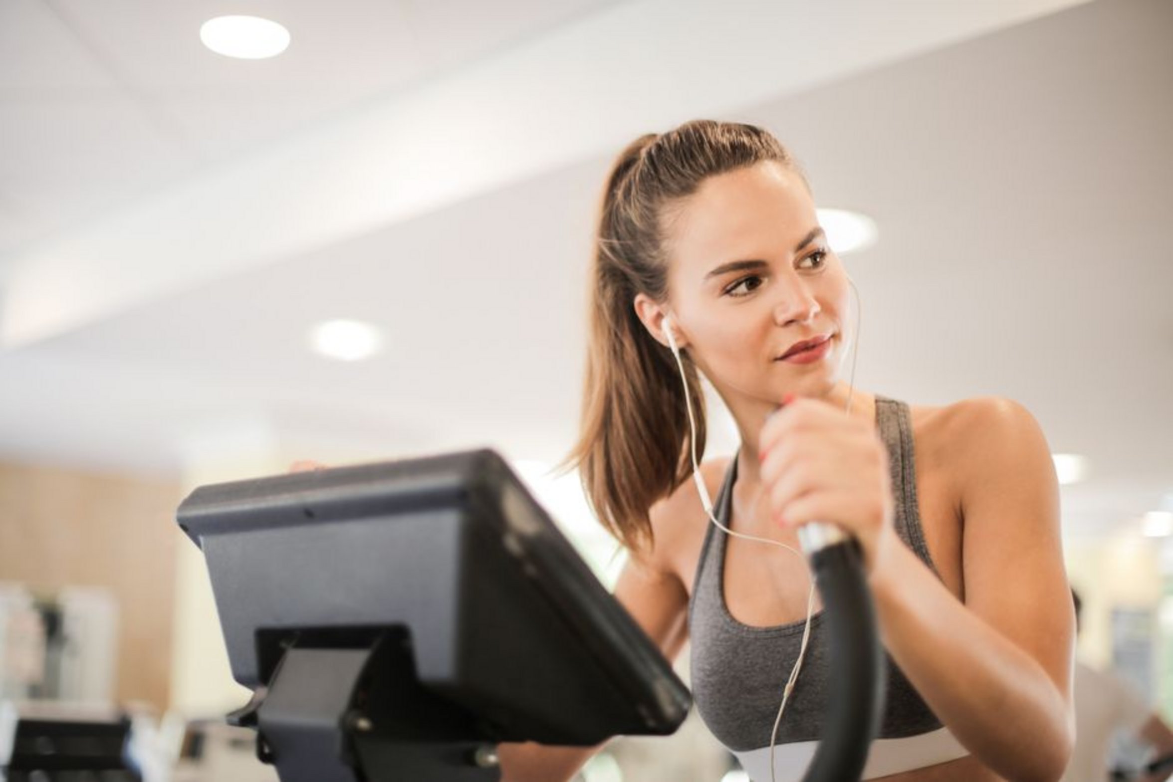 person using elliptical machine person using elliptical machine